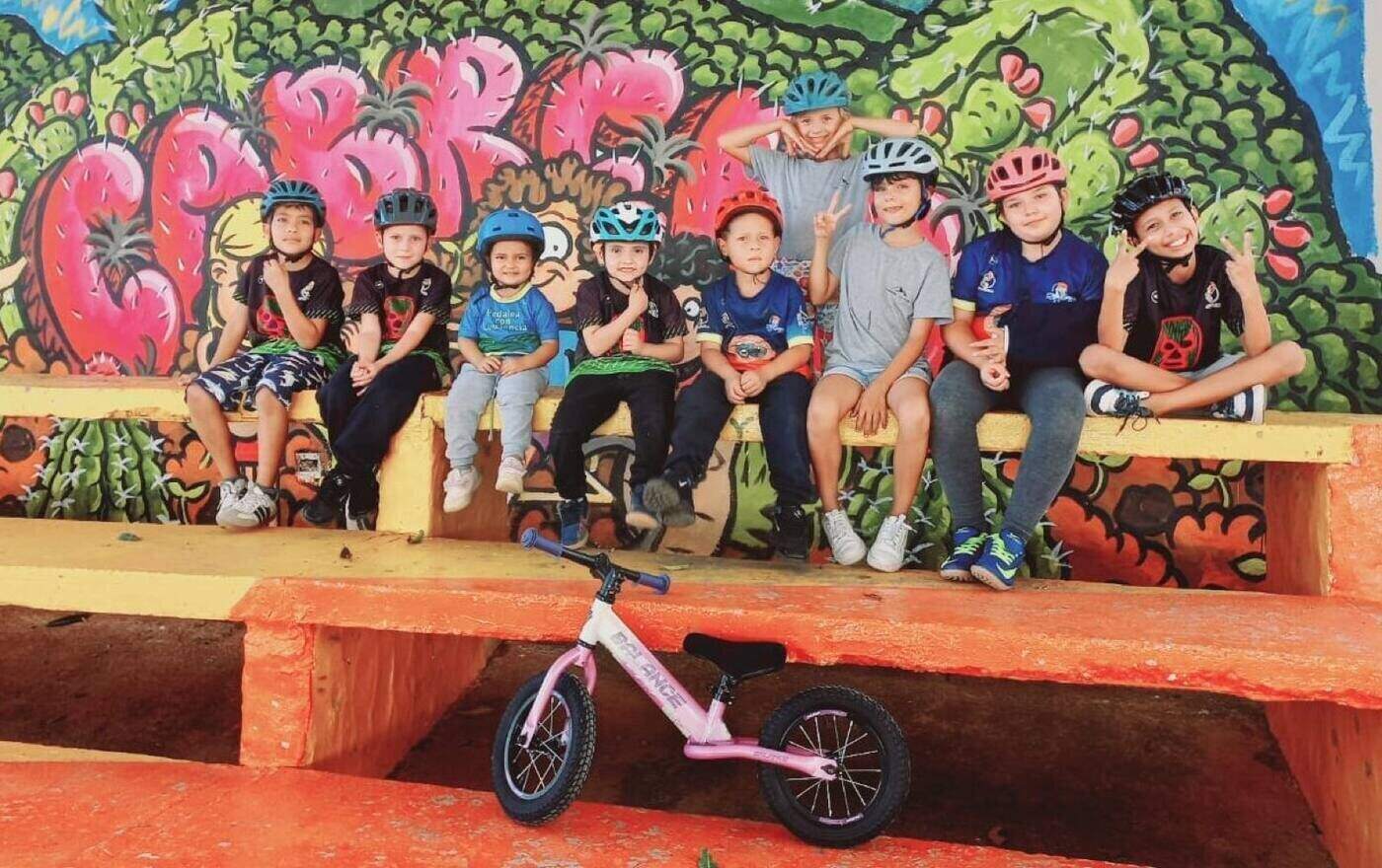 Young riders of Pedalea con Conciencia with their bikes on a road in Cabrera, Santander
